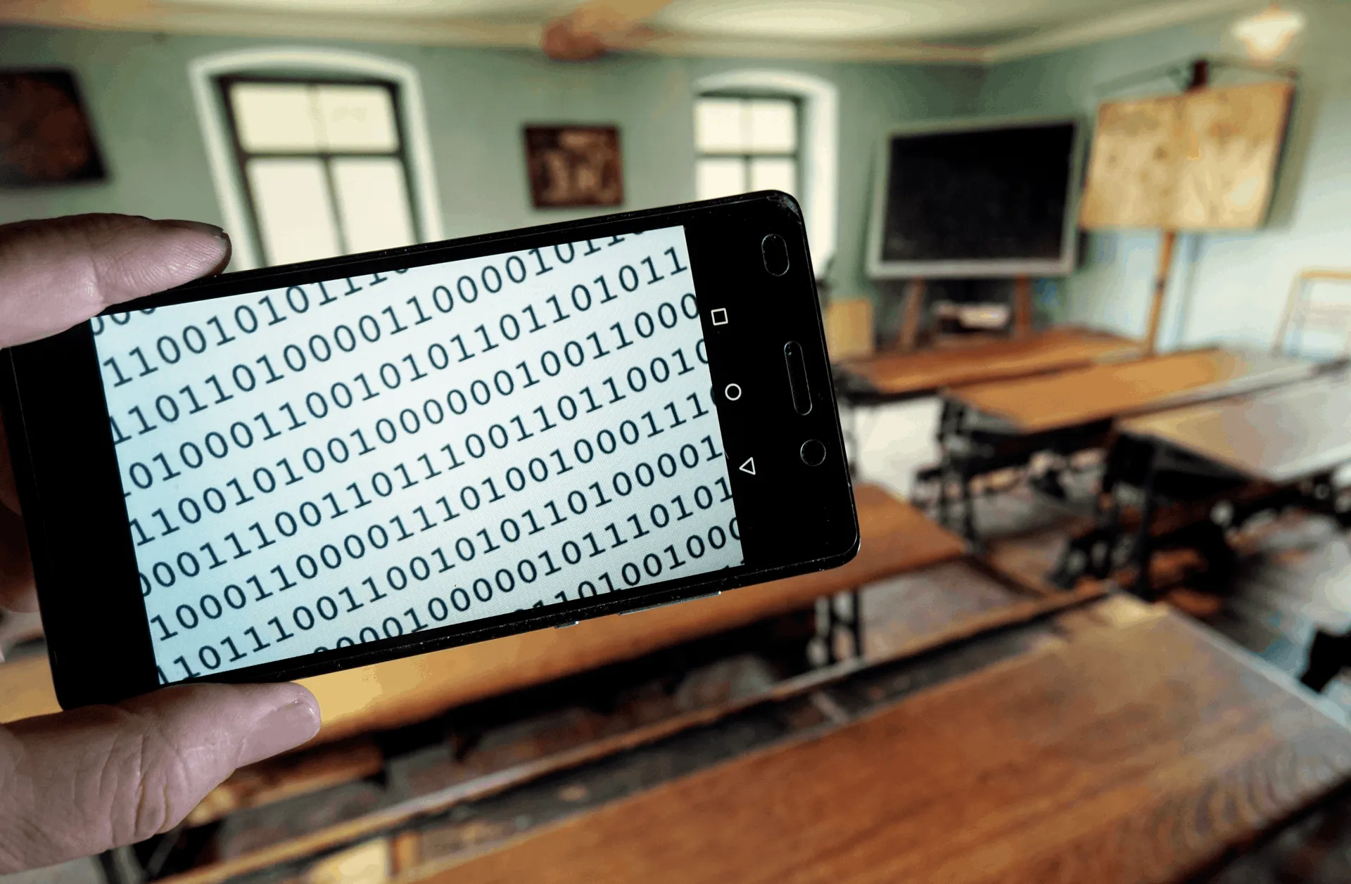 Text in binary code on the display of a smartphone